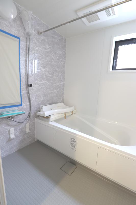 1号棟　2階浴室。白を基調とした明るい浴室。寒い日のお風呂や雨の日のお洗濯に便利な浴室乾燥機付。