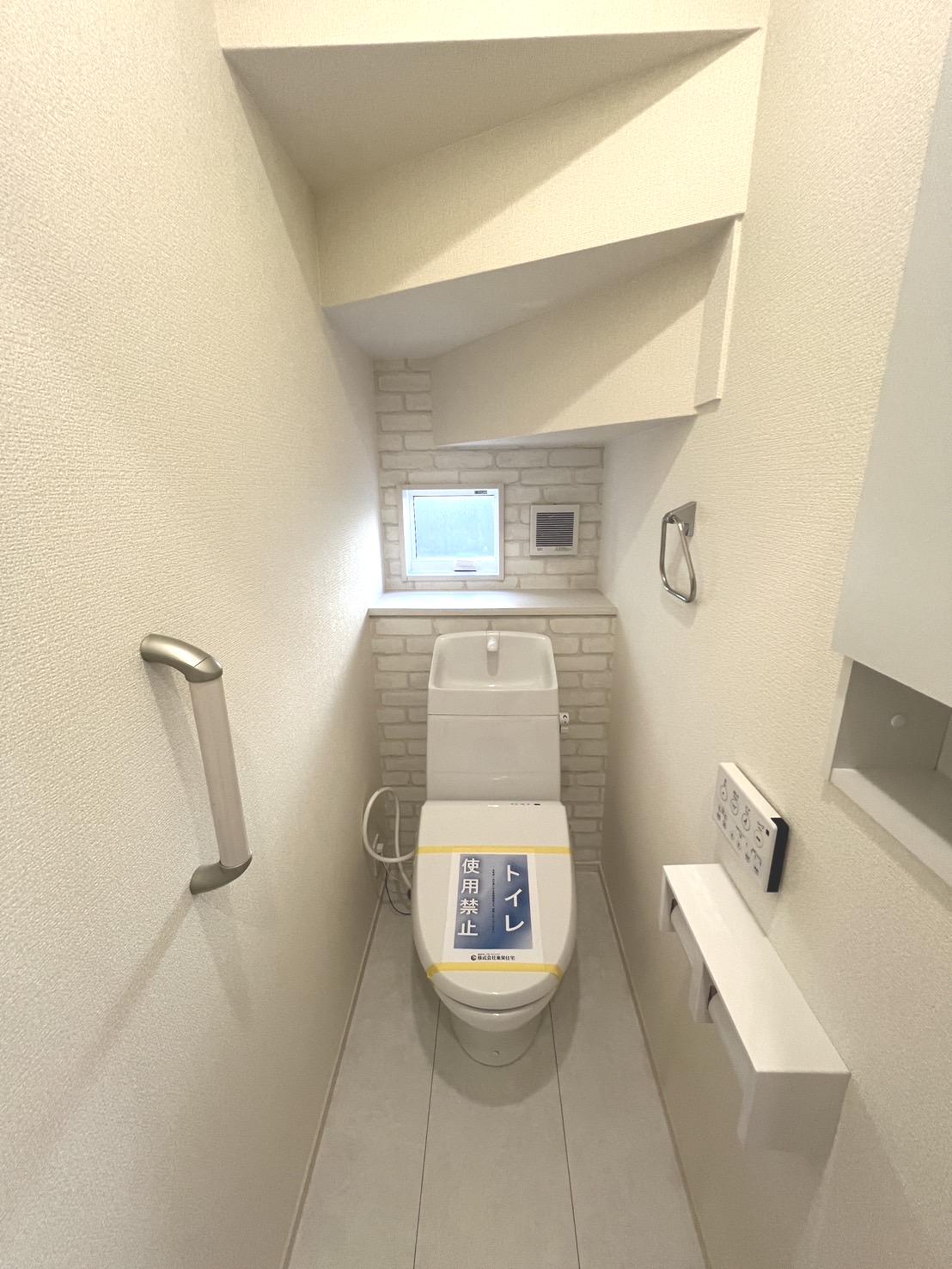 【1階トイレ】トイレにもアクセントクロスを採用、壁面収納、手すりなど設備も充実しています♪