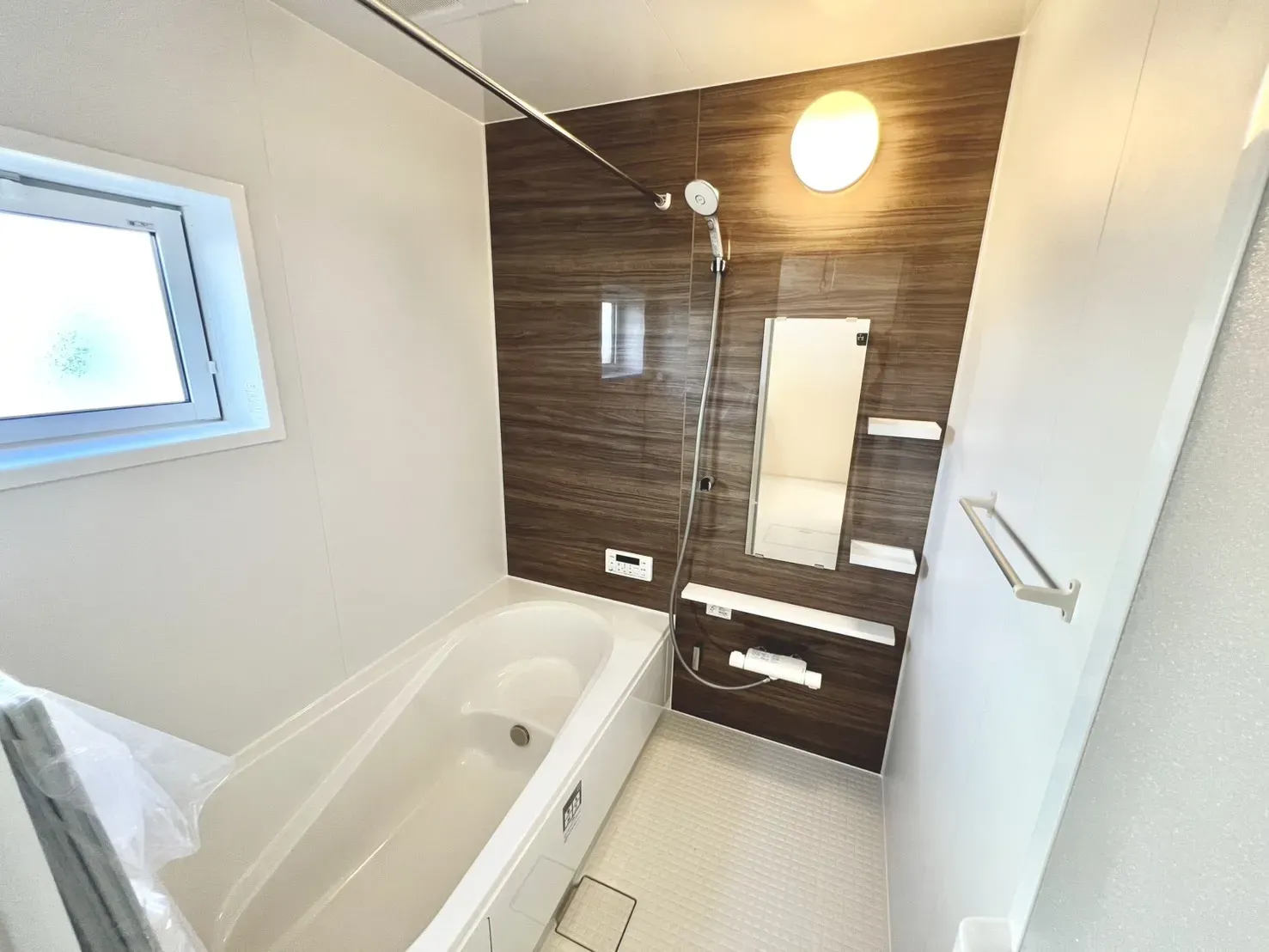 1日の疲れをゆっくりと癒せるバスルーム。落ち着いた雰囲気のブラウンのアクセントパネルを施しています。年中快適に洗濯物を乾かせる嬉しい浴室乾燥機付き。