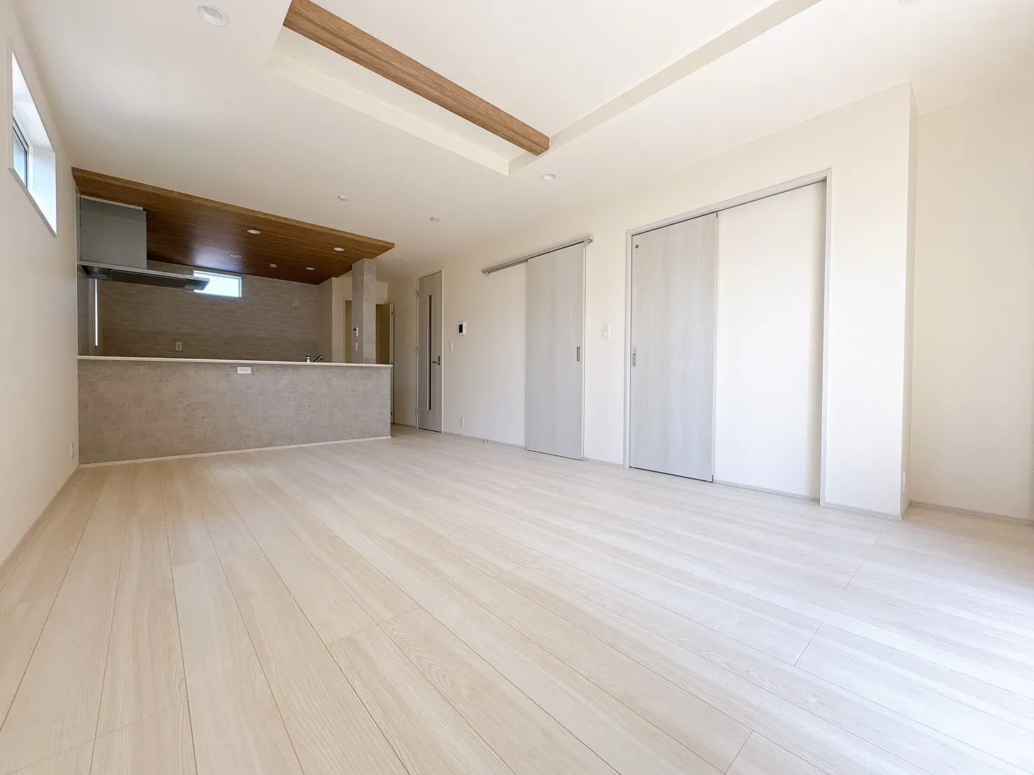 【1号棟LDK17.58帖)】アクセントクロス&折上天井を施した開放感のあるLDK。心地よい空間で、ゆったりと家族団欒のひとときをお過ごしいただけます。