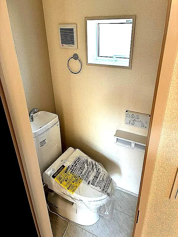 リモコン付きウォシュレットの2階トイレ　2連紙巻き器、手すり、タオル掛け、トイレ収納は標準装備。開口部があるので明るく清潔感が溢れています。